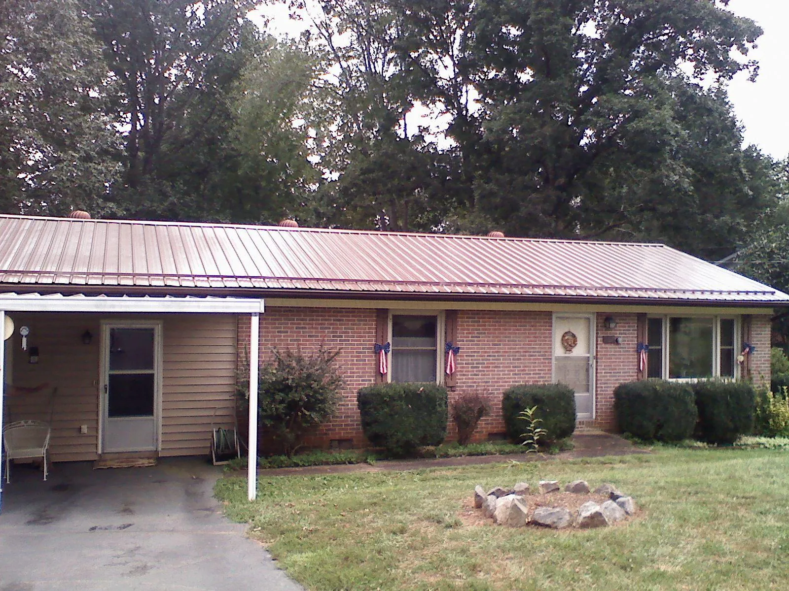 Bronze metal roof and carport on a brick ranch home — Roof Repair work by our crew in Elverson